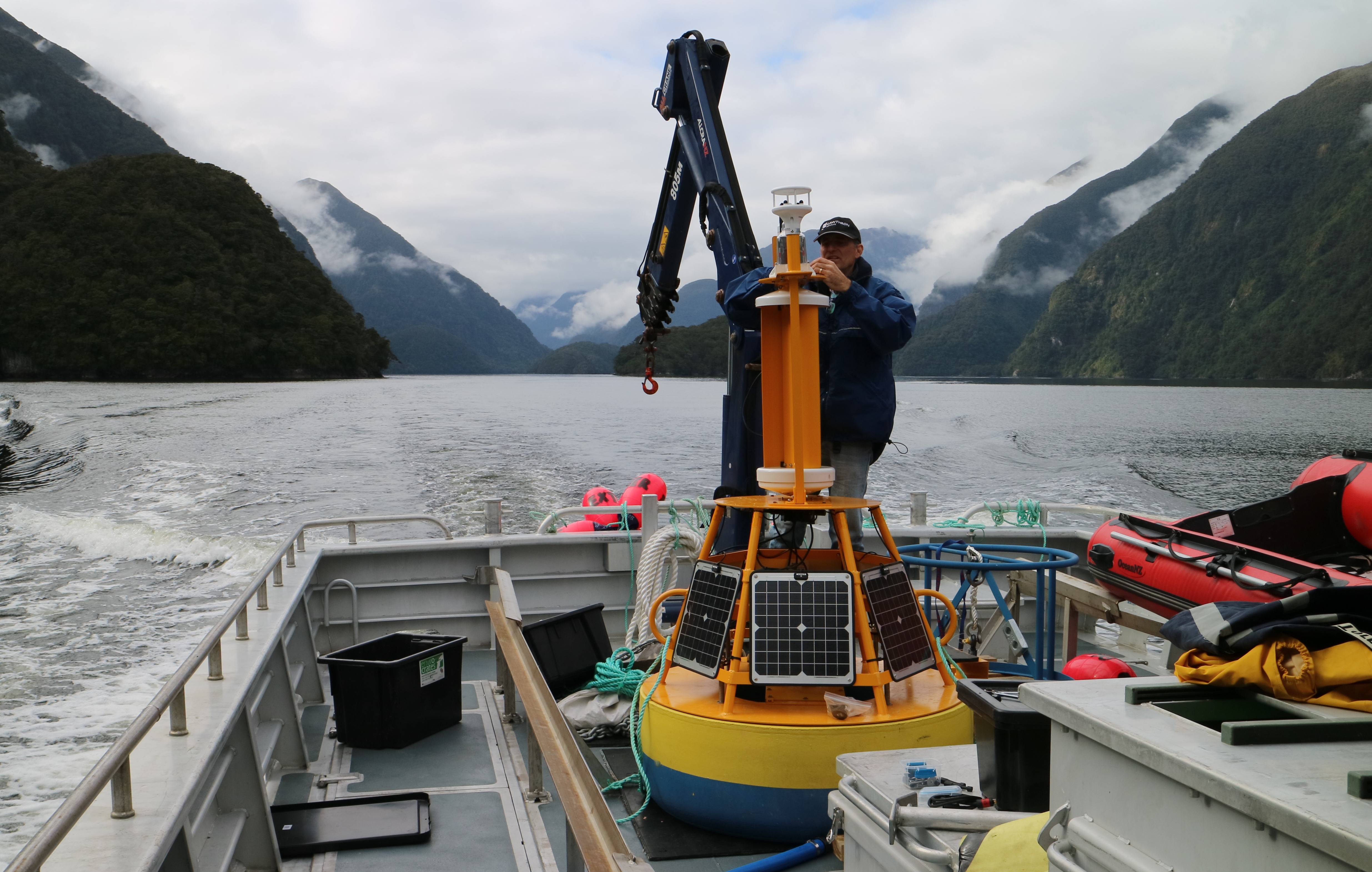 Cawthron Institute scientist Paul Barter deploying an upgraded Cawthron-designed wind and solar powered monitoring buoy in Milford Sound, Aotearoa New Zealand. Image courtesy of Cawthron Institute.